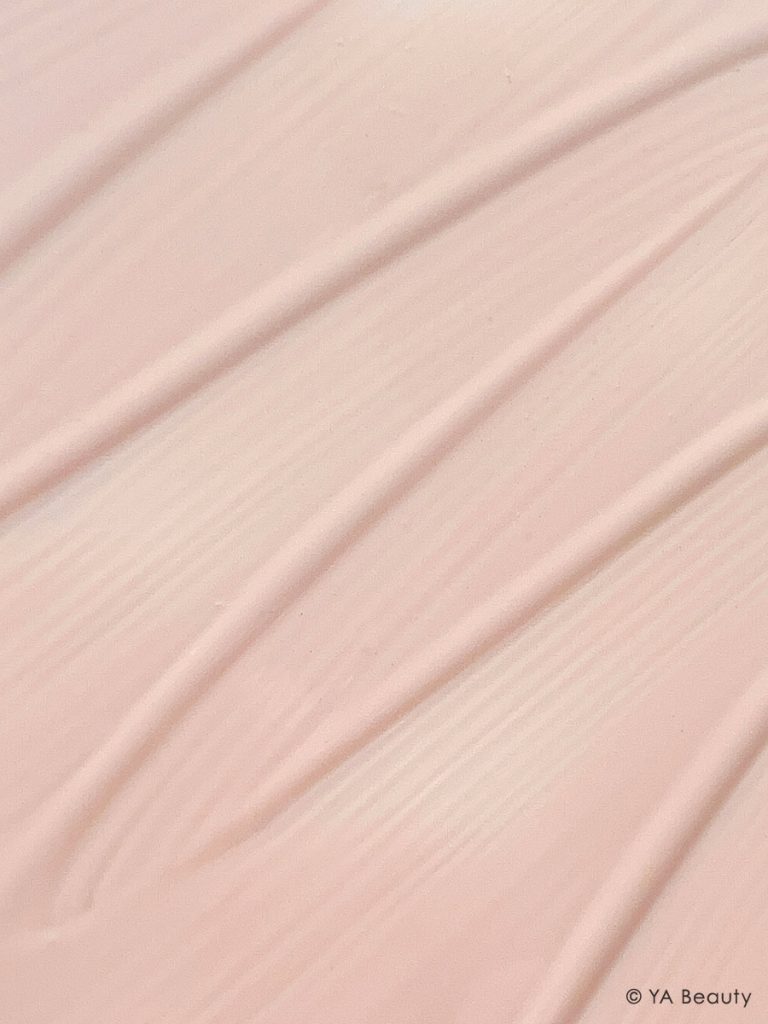 Macro photography of Westman Atelier Vital Skincare Complexion Drops foundation texture made in a sweeping zig zag.