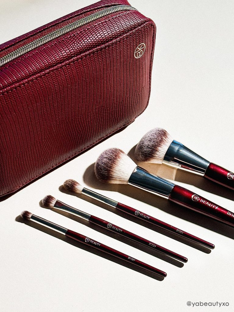 BK Beauty Travel Brush Set featuring the travel version of T101 Contoured Foundation Brush, T107 Flat Blush Brush, T202 Defined Crease Brush, T203 Eyeshadow Shader Brush, and T207 Pencil Blender Brush, as well as a vegan leather pouch in oxblood red color